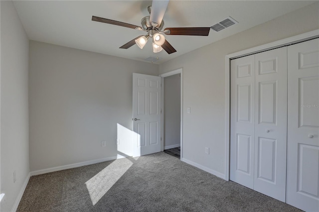 unfurnished bedroom featuring ceiling fan, a closet, and carpet