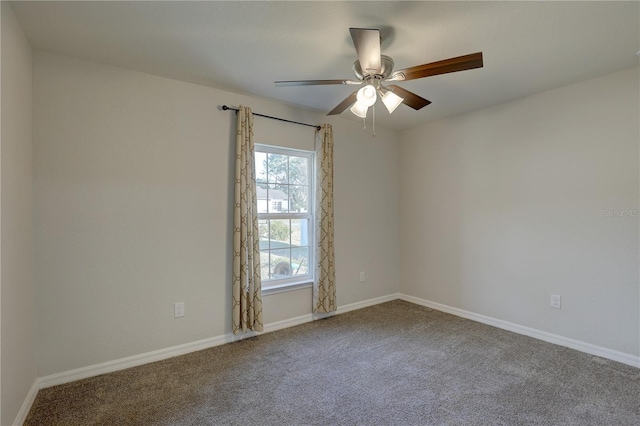 spare room featuring carpet flooring and ceiling fan