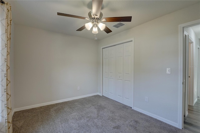 unfurnished bedroom featuring carpet flooring, ceiling fan, and a closet