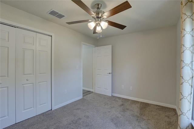 unfurnished bedroom featuring ceiling fan, a closet, and light carpet