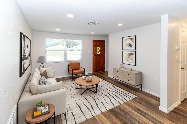 living room with dark hardwood / wood-style flooring