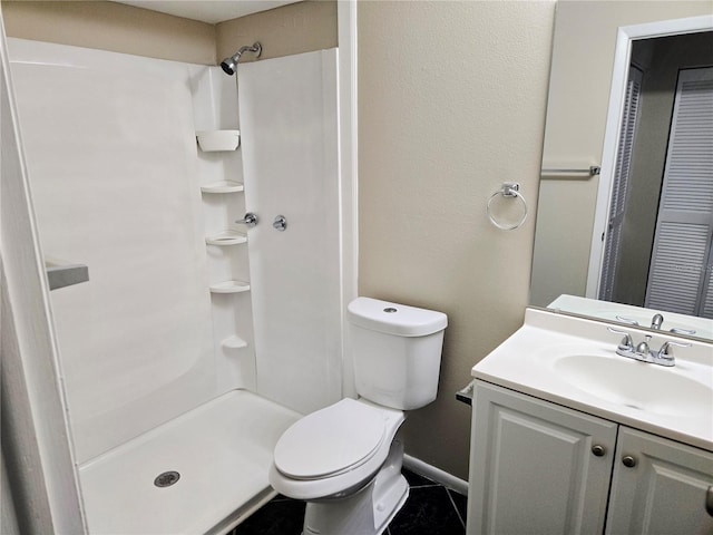 bathroom with a shower, tile patterned flooring, vanity, and toilet