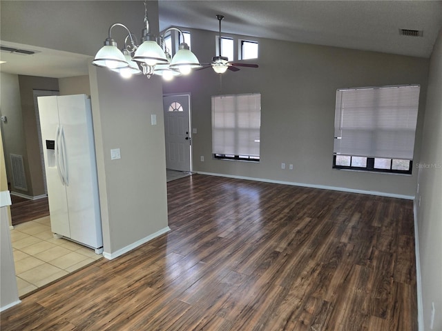 interior space featuring lofted ceiling, hardwood / wood-style floors, and ceiling fan with notable chandelier