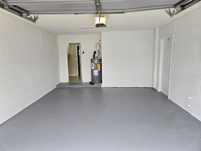 garage with electric water heater and a garage door opener