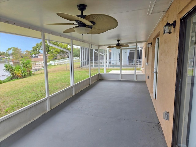 unfurnished sunroom featuring ceiling fan