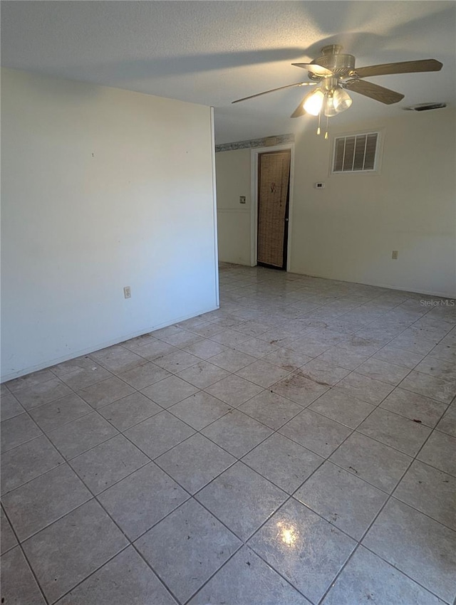 spare room featuring a textured ceiling and ceiling fan