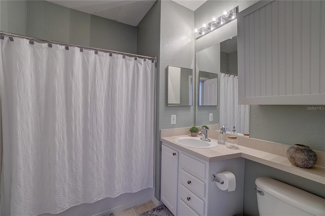 full bathroom with tile patterned flooring, shower / tub combo, vanity, and toilet