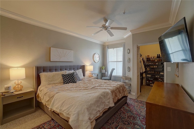 bedroom with carpet flooring, ceiling fan, a closet, and ornamental molding