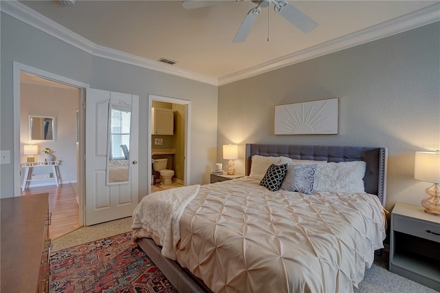 bedroom with ceiling fan, light hardwood / wood-style floors, ornamental molding, and ensuite bath