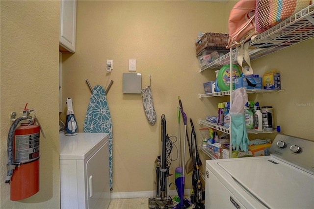 washroom featuring cabinets and washer and dryer