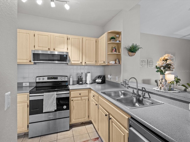 kitchen featuring stainless steel appliances, a sink, and light brown cabinetry