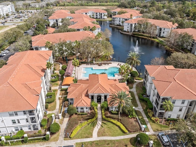 drone / aerial view with a water view and a residential view