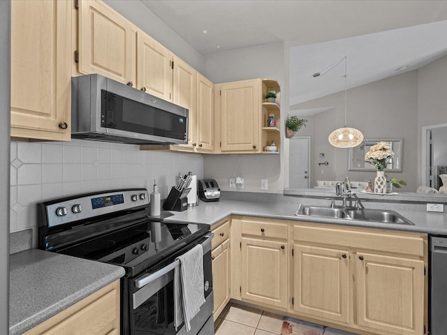 kitchen with light tile patterned floors, stainless steel appliances, tasteful backsplash, light brown cabinets, and a sink