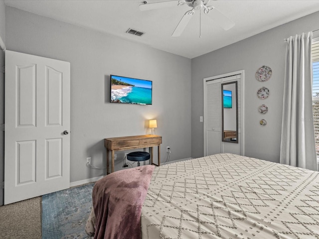 bedroom featuring baseboards, carpet floors, visible vents, and a ceiling fan