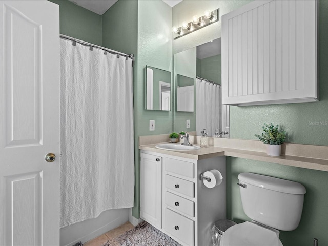 full bathroom featuring shower / bathtub combination with curtain, vanity, toilet, and tile patterned floors