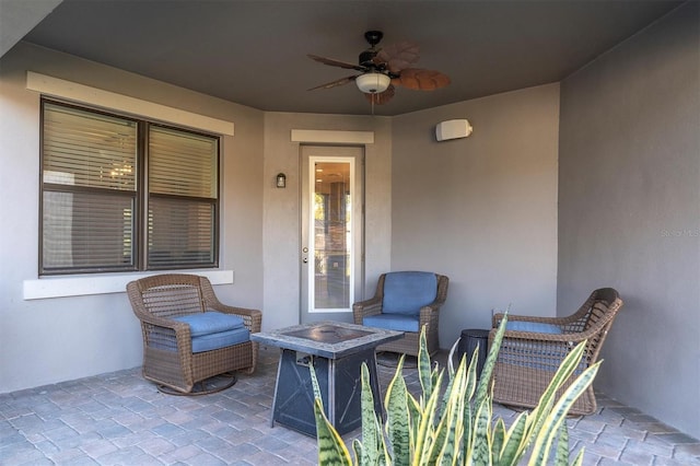 view of patio / terrace with ceiling fan and an outdoor fire pit