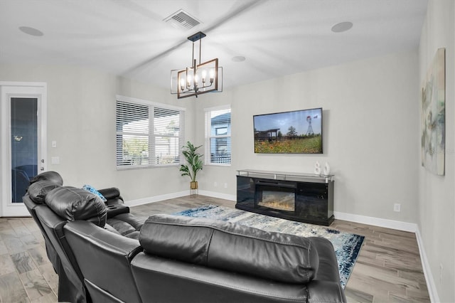 living room with hardwood / wood-style flooring and a notable chandelier