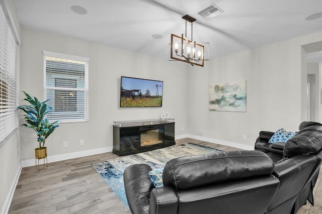 living room featuring light hardwood / wood-style floors and a chandelier