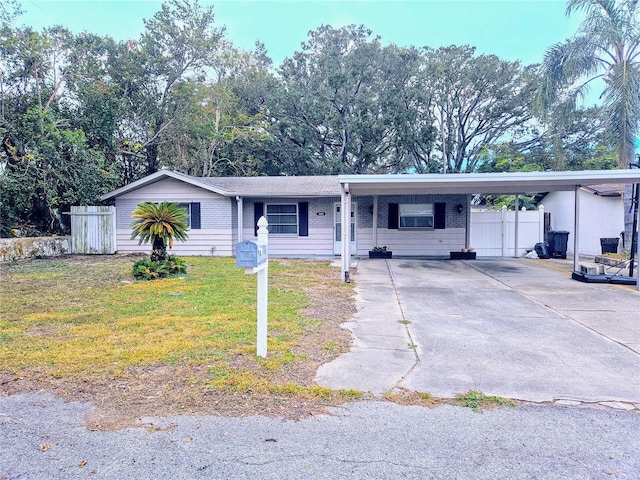 ranch-style home with a front yard and a carport