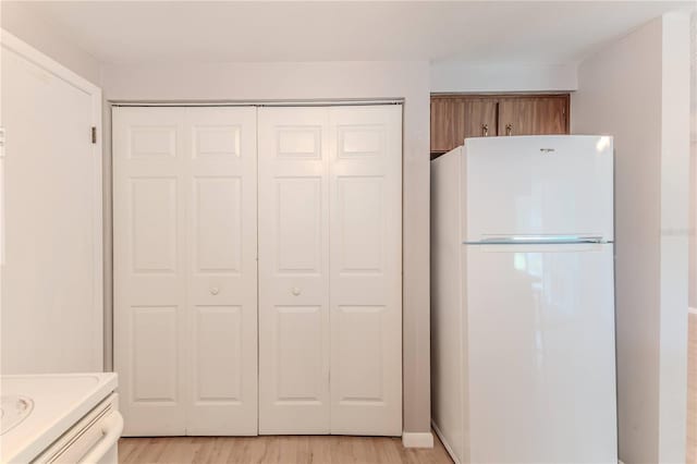 kitchen featuring light wood-type flooring and white refrigerator