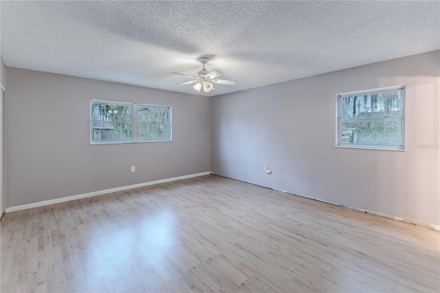 unfurnished room featuring a textured ceiling, light hardwood / wood-style flooring, and ceiling fan