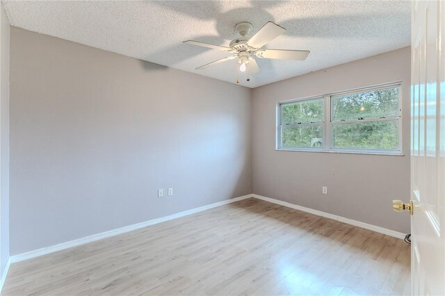 spare room featuring ceiling fan, a textured ceiling, and light hardwood / wood-style flooring