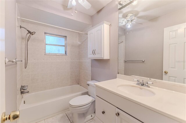 full bathroom featuring ceiling fan, toilet, tiled shower / bath, and vanity