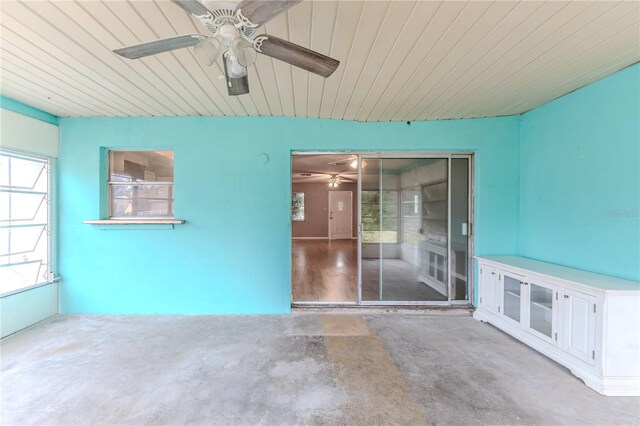 spare room featuring concrete floors and wooden ceiling