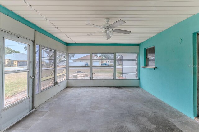 unfurnished sunroom with ceiling fan