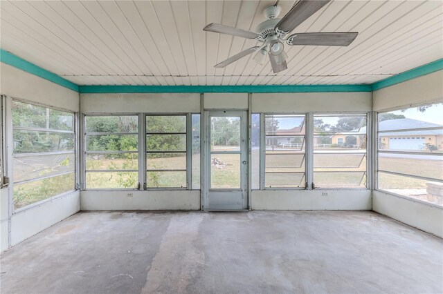 unfurnished sunroom with plenty of natural light and ceiling fan