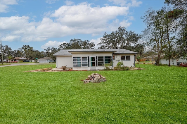 back of property featuring a yard