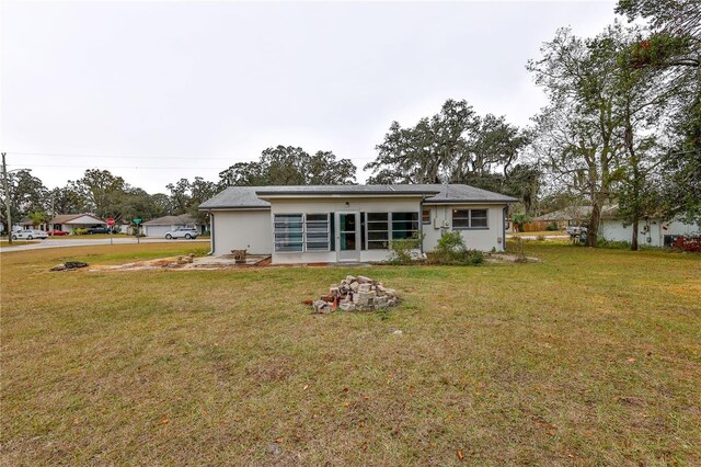 back of house with a lawn