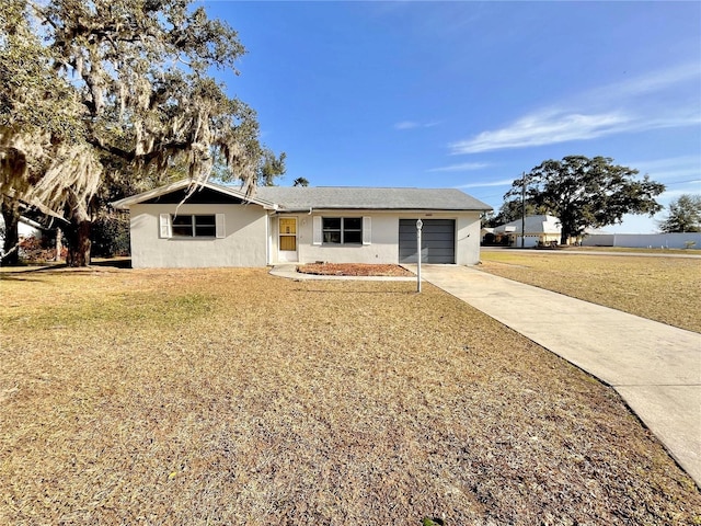 ranch-style home with a garage and a front yard