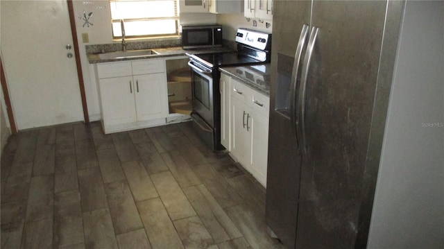 kitchen featuring white cabinetry, stainless steel appliances, and dark wood-type flooring