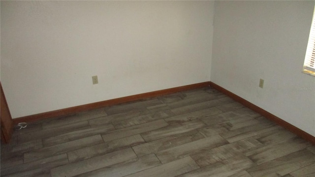 unfurnished room featuring dark hardwood / wood-style floors