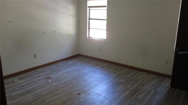 spare room featuring dark hardwood / wood-style floors