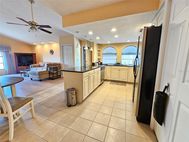 9163 Lingrove Rd, Weeki Wachee, FL 34613 - kitchen featuring stainless steel appliances, a textured ceiling, dark countertops, plenty of natural light, and open floor plan