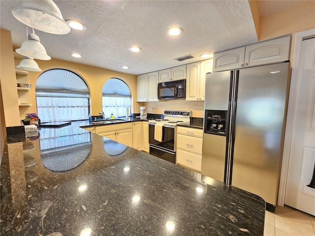 9163 Lingrove Rd, Weeki Wachee, FL 34613 - kitchen featuring black microwave, stainless steel fridge with ice dispenser, range with electric stovetop, dark stone countertops, and a peninsula