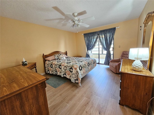 9163 Lingrove Rd, Weeki Wachee, FL 34613 - bedroom with access to exterior, light wood finished floors, a textured ceiling, and ceiling fan
