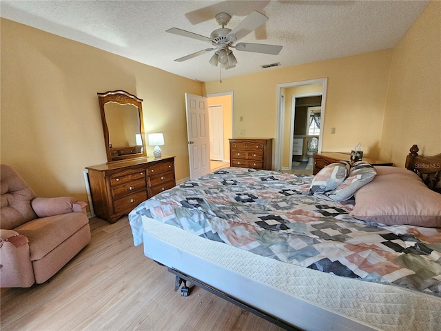 9163 Lingrove Rd, Weeki Wachee, FL 34613 - bedroom with light wood finished floors, a textured ceiling, and ceiling fan