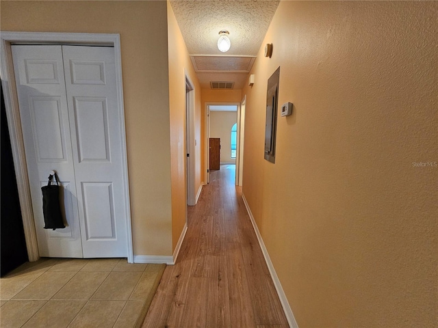 9163 Lingrove Rd, Weeki Wachee, FL 34613 - hall featuring a textured ceiling and light wood-type flooring