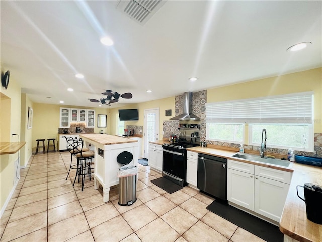 kitchen featuring wall chimney exhaust hood, sink, electric range, white cabinets, and black dishwasher