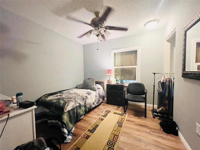 bedroom with ceiling fan and light wood-type flooring