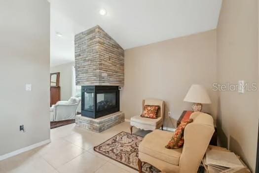 7941 Sycamore Dr, New Port Richey, FL 34654 - living room featuring lofted ceiling, a tile fireplace, and tile patterned floors