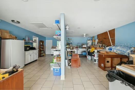 7941 Sycamore Dr, New Port Richey, FL 34654 - miscellaneous room featuring light tile patterned floors