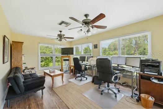7941 Sycamore Dr, New Port Richey, FL 34654 - office area with a ceiling fan and wood finished floors