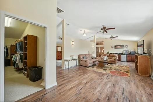 7941 Sycamore Dr, New Port Richey, FL 34654 - living room with lofted ceiling, a ceiling fan, and light wood-type flooring
