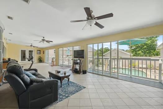 7941 Sycamore Dr, New Port Richey, FL 34654 - living room featuring a ceiling fan and tile patterned floors