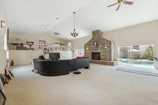 7941 Sycamore Dr, New Port Richey, FL 34654 - living area with vaulted ceiling, a ceiling fan, carpet, and a fireplace