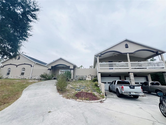 7941 Sycamore Dr, New Port Richey, FL 34654 - view of front facade with stucco siding, driveway, an attached garage, and a balcony